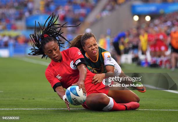 Charity Williams of Canada holds off Mathrin Simmers of South Africa to score a try during the Rugby Sevens Women's Pool A match between Canada and...