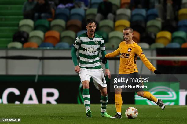 Atletico Madrids forward Antoine Griezmann of France vies with Sporting's defender Andre Pinto from Portugal during the UEFA Europa League second leg...