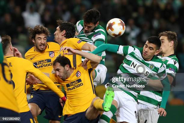 Sporting's midfielder Rodrigo Battaglia from Argentina vies with Atletico Madrids defenders Juanfran of Spain and Stefan Savic of Montenegro during...