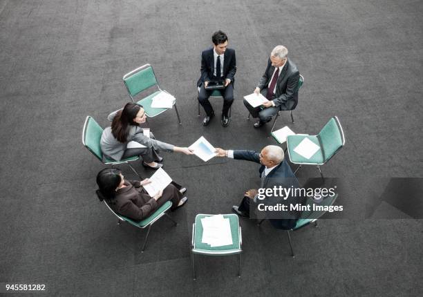 mixed race group of business people in an informal team building meeting. - five people stock-fotos und bilder