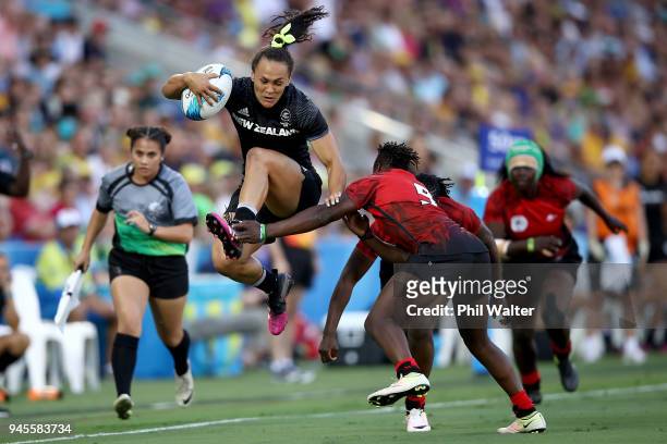 Portia Woodman of New Zealand jumps through a tackle in the match between New Zealand and Kenya during Rugby Sevens on day nine of the Gold Coast...