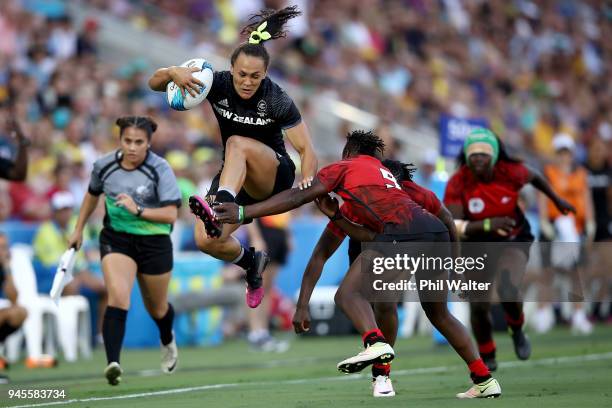 Portia Woodman of New Zealand jumps through a tackle in the match between New Zealand and Kenya during Rugby Sevens on day nine of the Gold Coast...