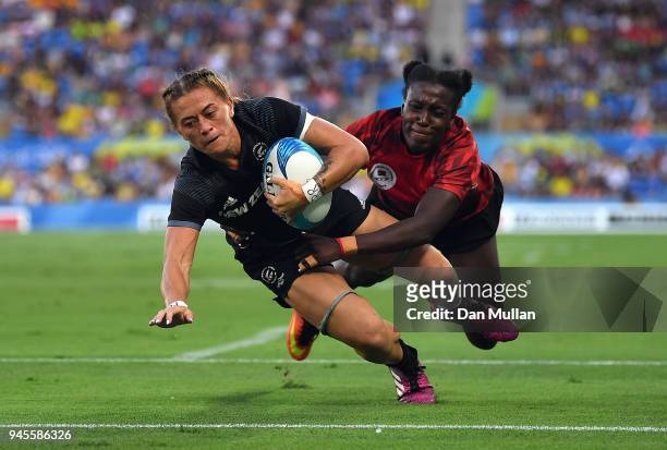 Niall Williams of New Zealand scores a try past Michelle Omondi of Kenya during the Rugby Sevens Women's Pool A match between New Zealand and Kenya...