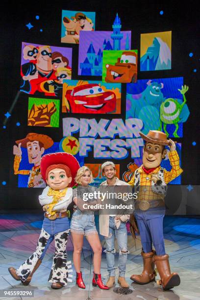 In this handout photo provided by Disney Resorts, Olivia Holt and Jordan Fisher pose with Pixar pals during the launch of the first Pixar Fest at...