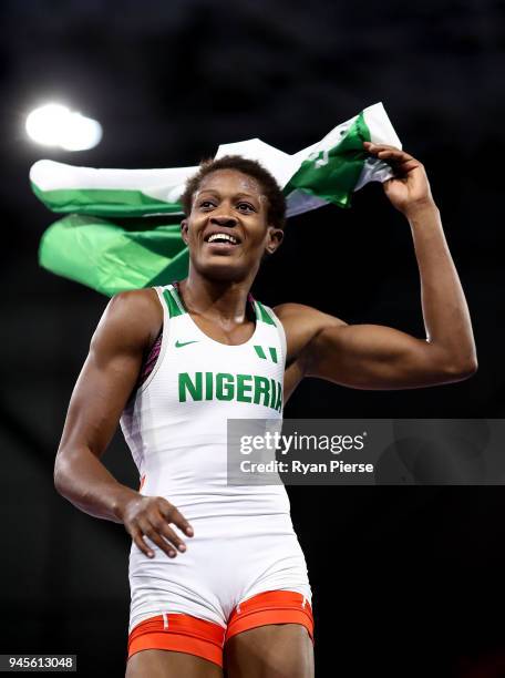 Odunayo Adekuoroye of Nigeria celebrates victory over Pooja Dhanda of India in the Women's Freestyle 57 kg Gold Medal match on day nine of the Gold...