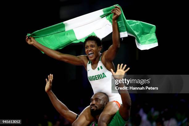 Odunayo Adekuoroye of Nigeria celebrates victory over Pooja Dhanda of India in the Women's Freestyle 57 kg Gold Medal match on day nine of the Gold...