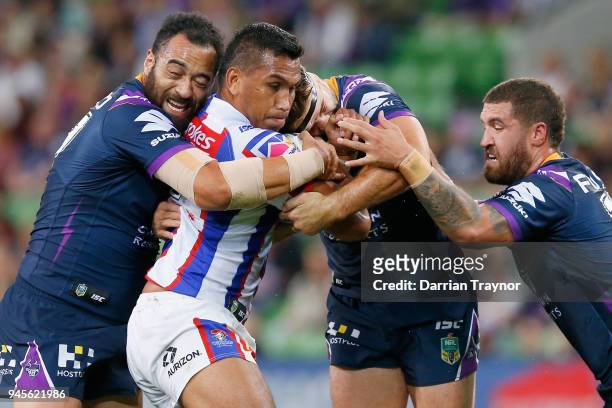 Jacob Saifiti of the Knights is tackled by Christian Welch of the Storm during the round six NRL match between the Melbourne Storm and the Newcastle...