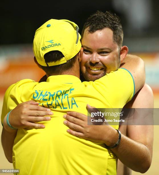 Aaron Wilson of Australia hugs Aron Sherrife after winning the gold medal in the men's singles gold medal match between Aaron Wilson of Australia and...