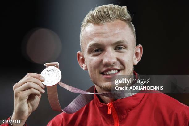 Silver medallist Englands Kyle Langford celebrates on the podium for the athletics men's 800m final during the 2018 Gold Coast Commonwealth Games at...