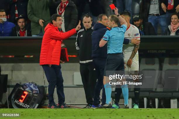 Referee William Collum shows a red card to Joaquin Correa of Sevilla during the UEFA Champions League quarter final second leg match between Bayern...