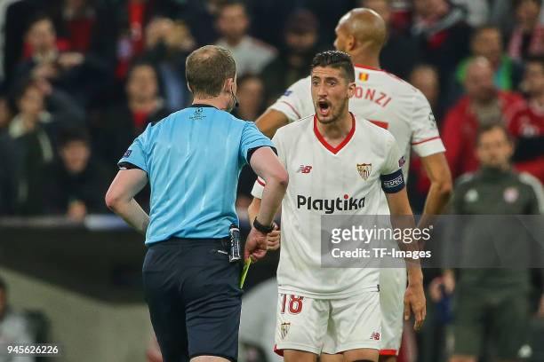 Referee William Collum argues with Sergio Escudero of Sevilla during the UEFA Champions League quarter final second leg match between Bayern Muenchen...