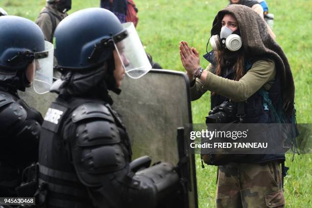 Protester reacts in front of gendarmerie officers, on April 13, 2018 at the ZAD in Notre-Dame-des-Landes, western France, during a police operation...