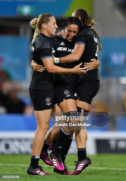 Sarah Goss of New Zealand celebrates scoring a try with Kelly Brazier and Tenika Willison of New Zealand during the Rugby Sevens Women's Pool A match...