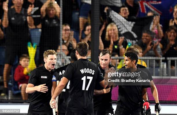 Stephen Jenness of New Zealand celebrates with team mates after scoring a goal in the semi final match between New Zealand and India during Hockey on...