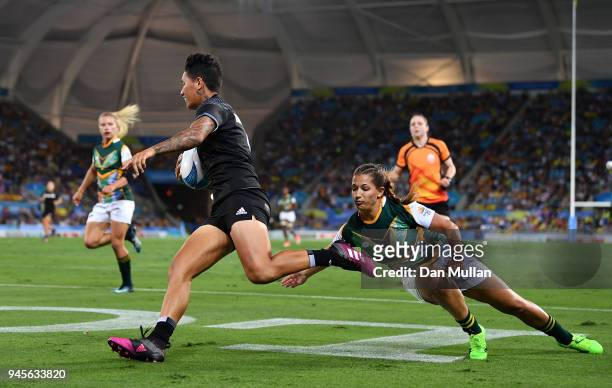 Gayle Broughton of New Zealand makes a break to score during the Rugby Sevens Women's Pool A match between New Zealand and South Africa on day nine...
