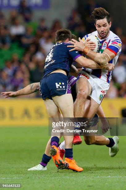 Curtis Scott of the Storm tackles Aiden Guerra of the Knights during the round six NRL match between the Melbourne Storm and the Newcastle Knights at...