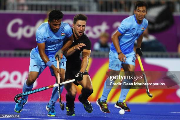 Harmanpreet Singh of India battles for the ball with Kane Russell of New Zealand during Men's Semifinal match between India and New Zealand on day...