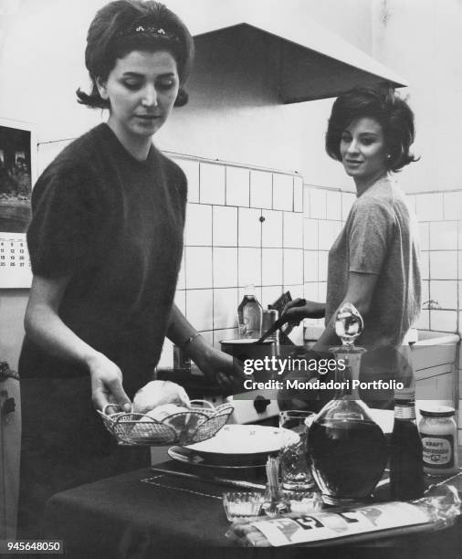 Two young women cooking. A new social issue, that came up in the early Sisties, in Italy - thousands of young women leaving their families to live...