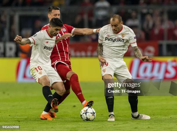 Ever Banega of Sevilla, Sandro Ramirez of Sevilla and Sandro Wagner of Muenchen battle for the ball during the UEFA Champions League quarter final...