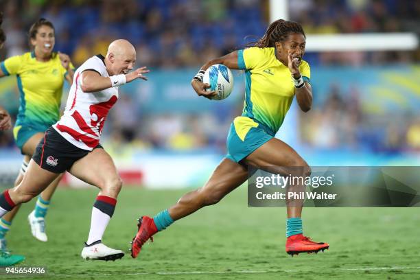 Ellia Green of Australia runs in for a try in the match between Australia and England during Rugby Sevens on day nine of the Gold Coast 2018...