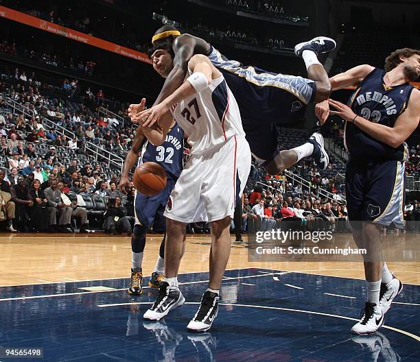 Zaza Pachulia of the Atlanta Hawks gets fouled by Zach Randolph of the Memphis Grizzlies on December 16, 2009 at Philips Arena in Atlanta, Georgia....