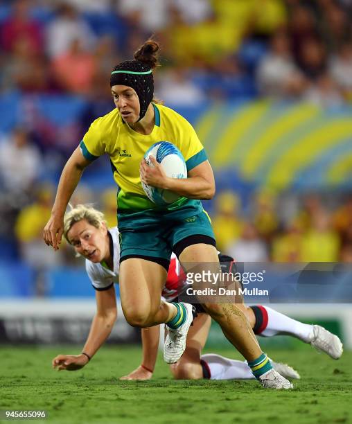 Emilee Cherry of Australia makes a break during the Rugby Sevens Women's Pool B match between Australia and England on day nine of the Gold Coast...
