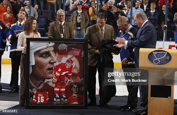 Ron Sutter of the Calgary Flames organization presents Brett Hull with a collage of images from his days with the Flames during Brett Hull Hall of...