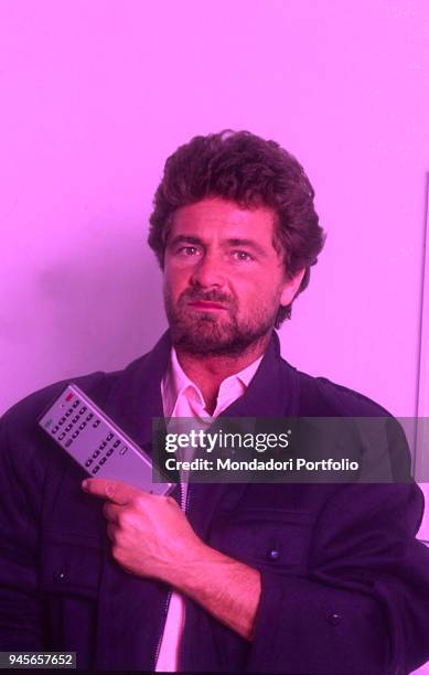 The comedian Beppe Grillo holding a remote control. 1985