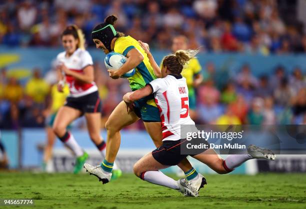 Emilee Cherry of Australia is tackled by Natasha Hunt of England during the Rugby Sevens Women's Pool B match between Australia and England on day...