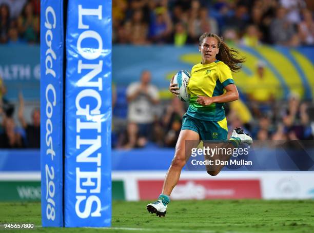Vani Pelite of Australia runs in to score a try during the Rugby Sevens Women's Pool B match between Australia and England on day nine of the Gold...
