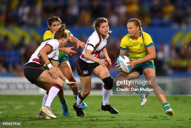 Emma Sykes of Australia takes on Emily Scott of England during the Rugby Sevens Women's Pool B match between Australia and England on day nine of the...