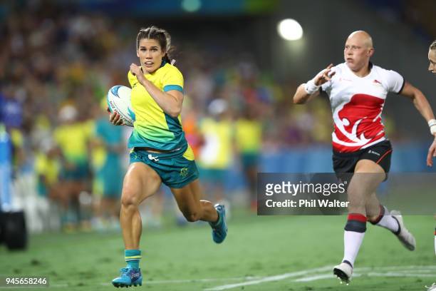 Charlotte Caslick of Australia makes a break in action during in the match between Australia and England during Rugby Sevens on day nine of the Gold...