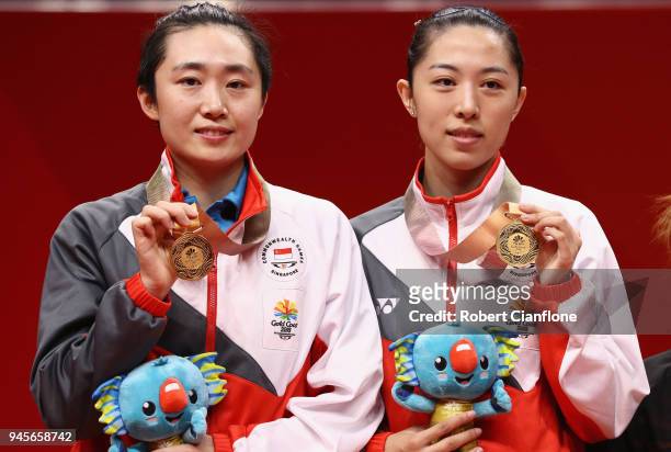 Tianwei Feng and Mengyu Yu of Singapore pose with the gold medal after winning the WomenÕs Doubles Table Tennis Gold Medal Match on day nine of the...