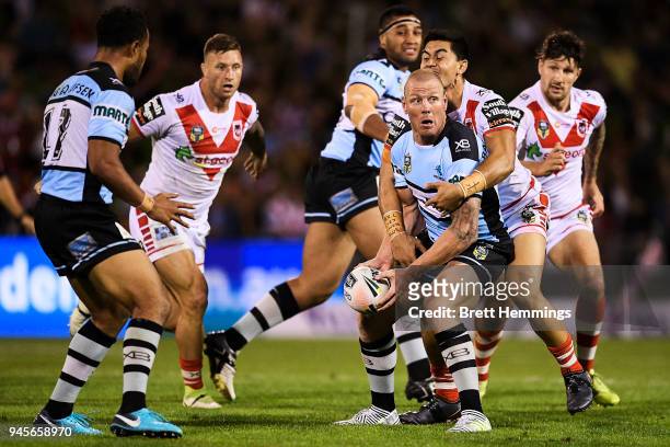 Luke Lewis of the Sharks offloads the ball during the round six NRL match between the St George Illawarra Dragons and the Cronulla Sharks at WIN...