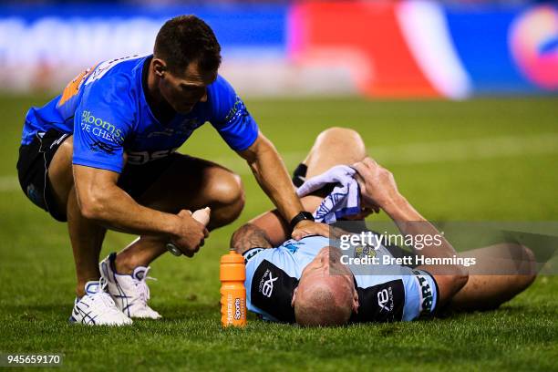 Luke Lewis of the Sharks lays injured on the field during the round six NRL match between the St George Illawarra Dragons and the Cronulla Sharks at...