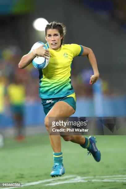 Charlotte Caslick of Australia makes a break during in the match between Australia and England during Rugby Sevens on day nine of the Gold Coast 2018...