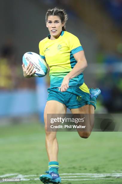 Charlotte Caslick of Australia makes a break during in the match between Australia and England during Rugby Sevens on day nine of the Gold Coast 2018...