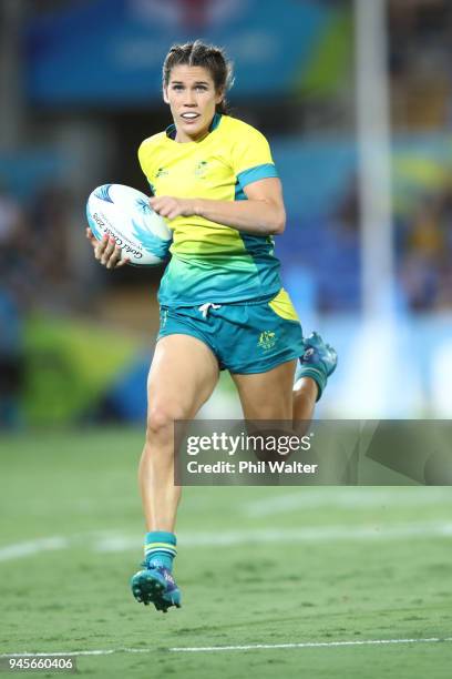 Charlotte Caslick of Australia makes a break during in the match between Australia and England during Rugby Sevens on day nine of the Gold Coast 2018...