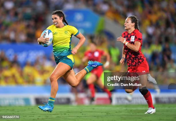 Charlotte Caslick of Australia is chases down by Jasmine Joyce of Wales during the Rugby Sevens Women's Pool B match between Australia and Wales on...