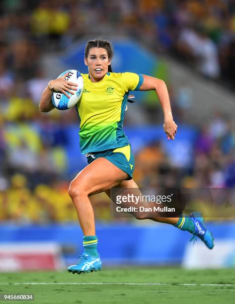 Charlotte Caslick of Australia makes a break during the Rugby Sevens Women's Pool B match between Australia and Wales on day nine of the Gold Coast...