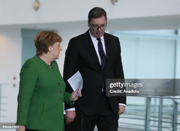 German Chancellor Angela Merkel and Serbian President Aleksandar Vucic walk to hold a joint press conference prior to their meeting in Berlin,...