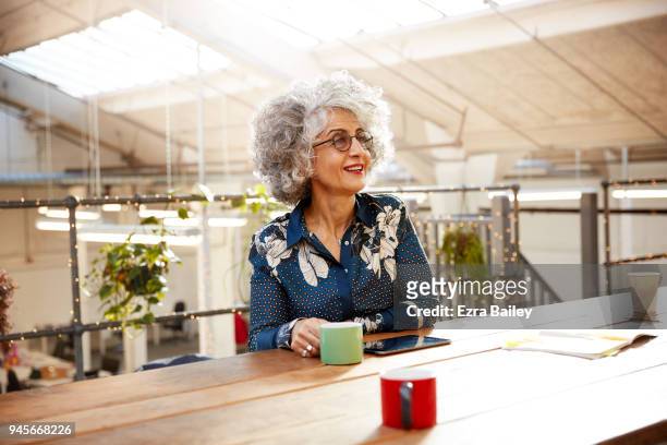 Creative woman working in industrial office space.