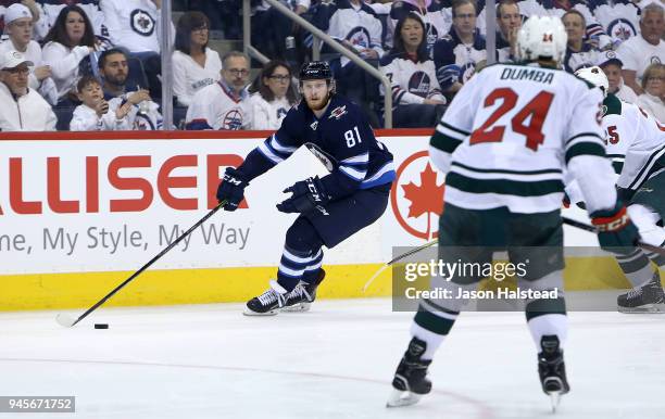 Kyle Connor of the Winnipeg Jets looks to get past Jonas Brodin and Matt Dumba of the Minnesota Wild in Game One of the Western Conference First...