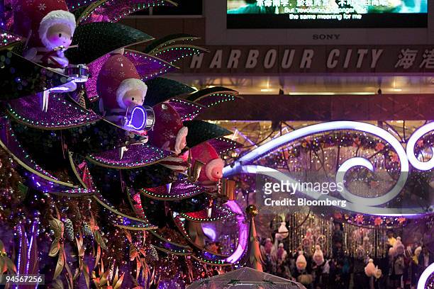 Revelers admire the Christmas decorations outside a shopping mall in Hong Kong, China, on Sunday, Dec. 13, 2009. The Hong Kong Monetary Authority...