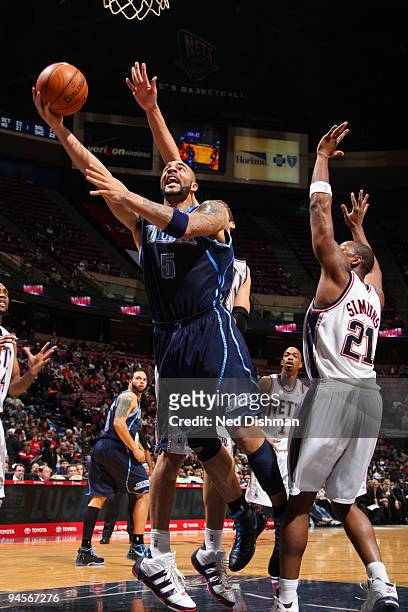 Carlos Boozer of the Utah Jazz shoots against Bobby Simmons of the New Jersey Nets on December 16, 2009 at the IZOD Center in East Rutherford, New...