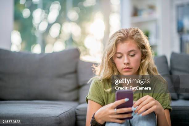 girl looking at messages - good; times bad times stock pictures, royalty-free photos & images