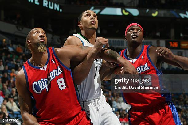 Ryan Hollins of the Minnesota Timberwolves fights for position against Brian Skinner and Al Thornton of the Los Angeles Clippers during the game on...