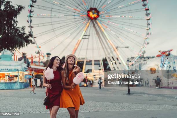 happy women at the amusement park - joy ride stock pictures, royalty-free photos & images