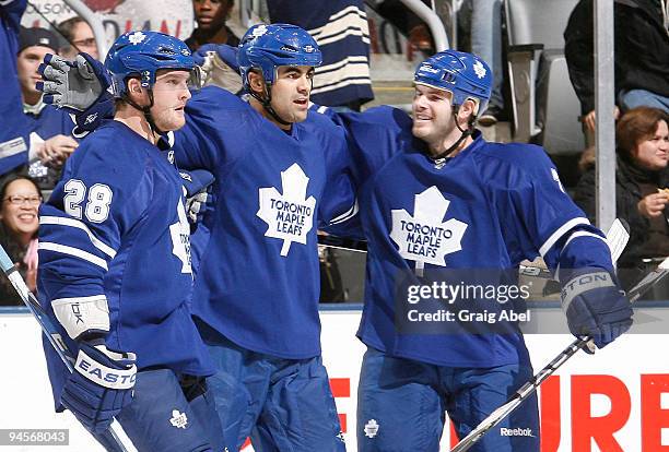 Colton Orr, Jamal Mayers Ian White of the Toronto Maple Leafs celebrate a second period goal against the Phoenix Coyotes during game action December...