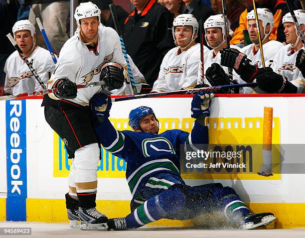 Darcy Hordichuk of the Vancouver Canucks slams into the boards after being checked by Nick Boynton of the Anaheim Ducks during their game at General...